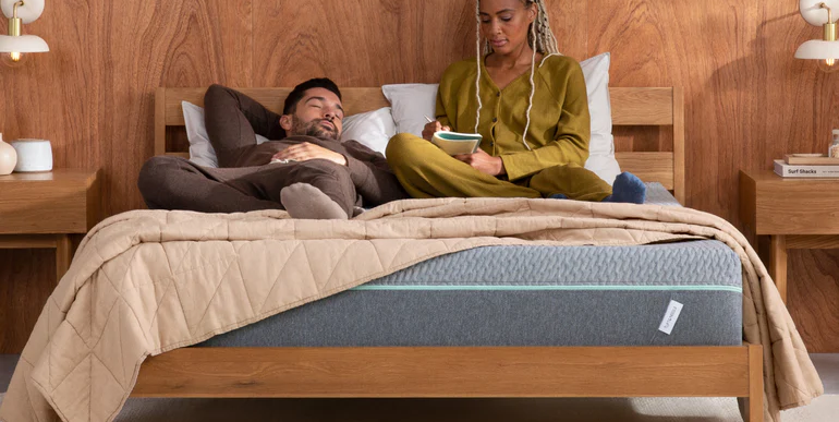 couple relaxing on tuft and needle mattress