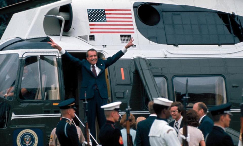 Richard M. Nixon;David EisenhowerPres. Richard Nixon raising hands w. trademark V signs in doorway of helicopter after leaving White House following his resignation over the Watergate scandal, 9th August 1974. (visible on ground is son-in-law David Eisenhower, glasses & tie) (Photo by Bill Pierce//Time Life Pictures/Getty Images)