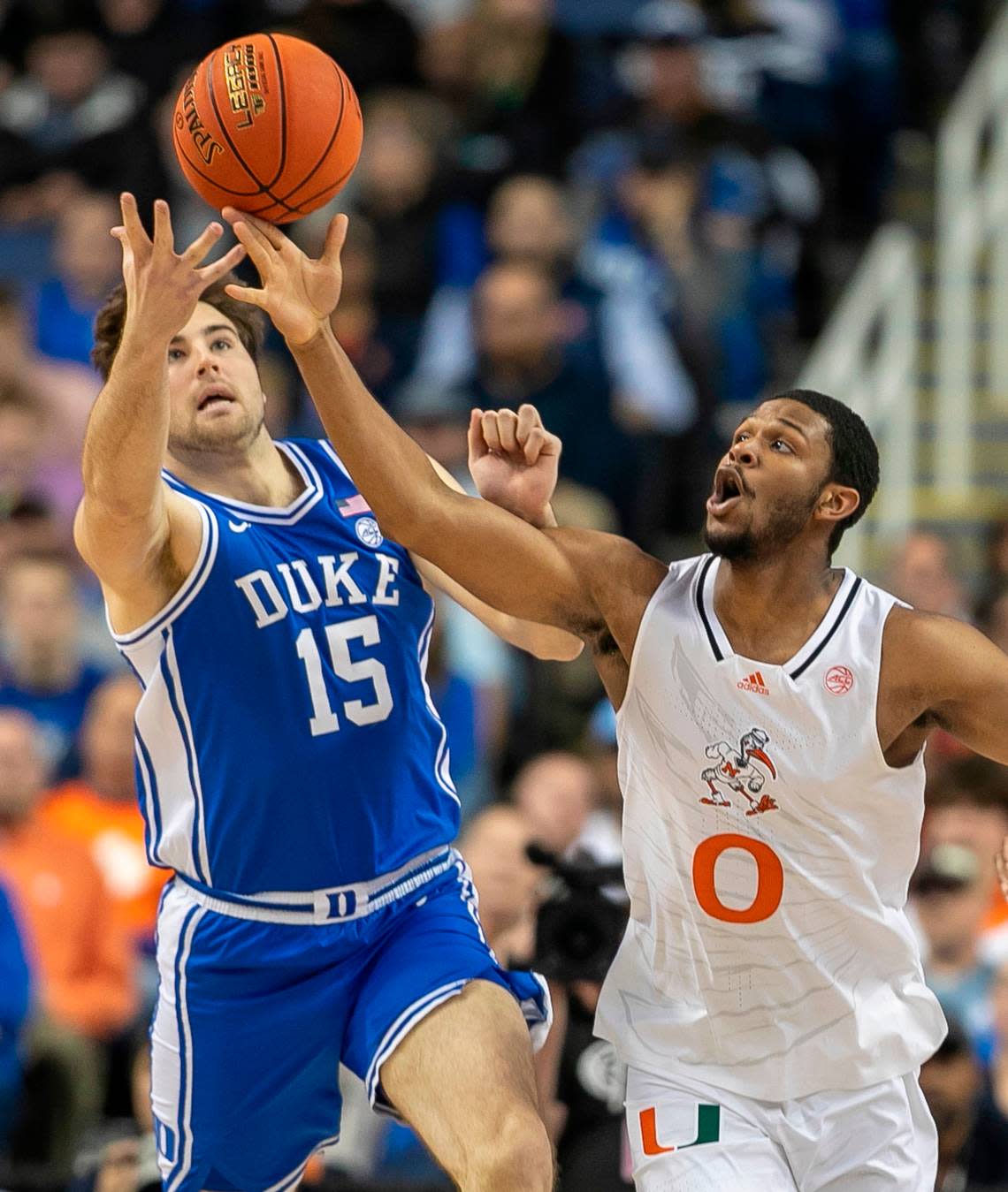 Duke’s Ryan Young (15) and Miami’s A.J. Casey (0) chase a loose ball in the second half during in the semi-finals of the ACC Tournament on Friday, March 10, 2023 at the Greensboro Coliseum in Greensboro, N.C.