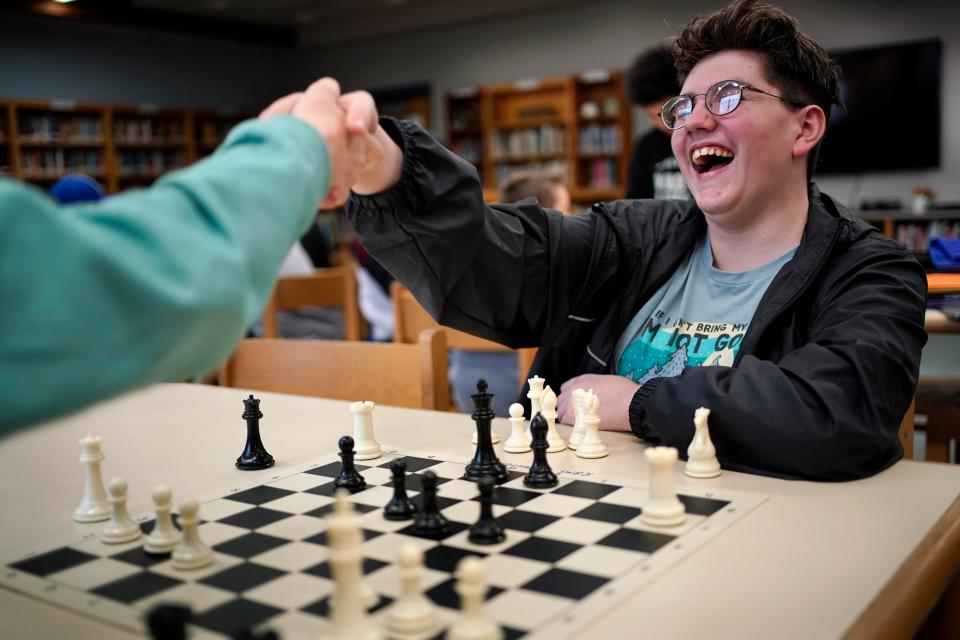 Reeds Brook Middle School chess team member Lucien Paradis shakes hands after defeating his opponent during an after-school chess practice, Tuesday, April 25, 2023, in Hampden, Maine. Part-time chess coach and full-time custodian David Bishop led his elementary and middle school teams to state championship titles this year.