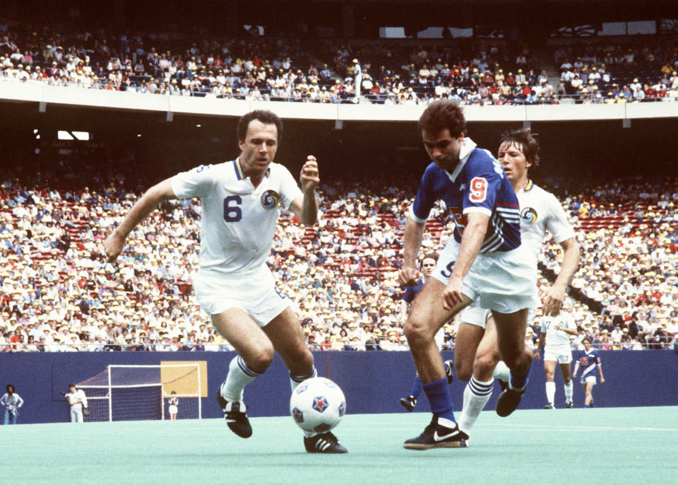 FILE - New York Cosmos Franz Beckenbauer (6) battles for the ball during an MLS soccer game, May 1, 1983 in East Rutherford, N.J. Germany's World Cup-winning coach Franz Beckenbauer has died. He was 78. Beckenbauer was one of German soccer's central figures. He captained West Germany to the World Cup title in 1974. He also coached the national side for its 1990 World Cup win against Argentina. (AP Photo, File)