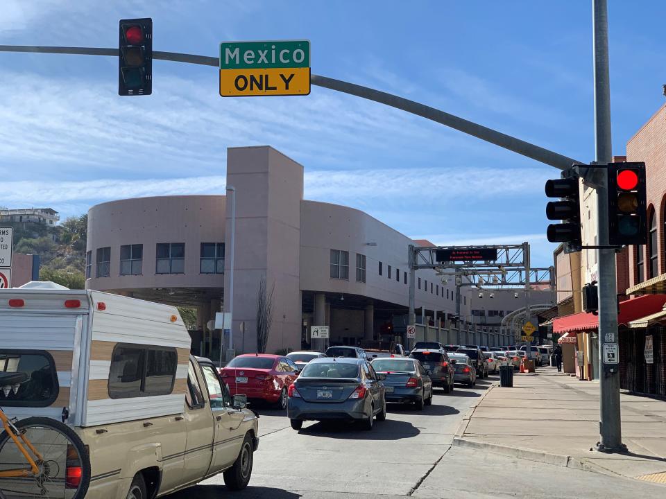 Lines of cars driving southbound into Mexico stretch into downtown Nogales, Arizona, on Dec. 17, 2020. Thousands of Mexicans and Mexican Americans are expected to visit relatives in Mexico during the holiday season, despite recommendations from health officials to stay home.