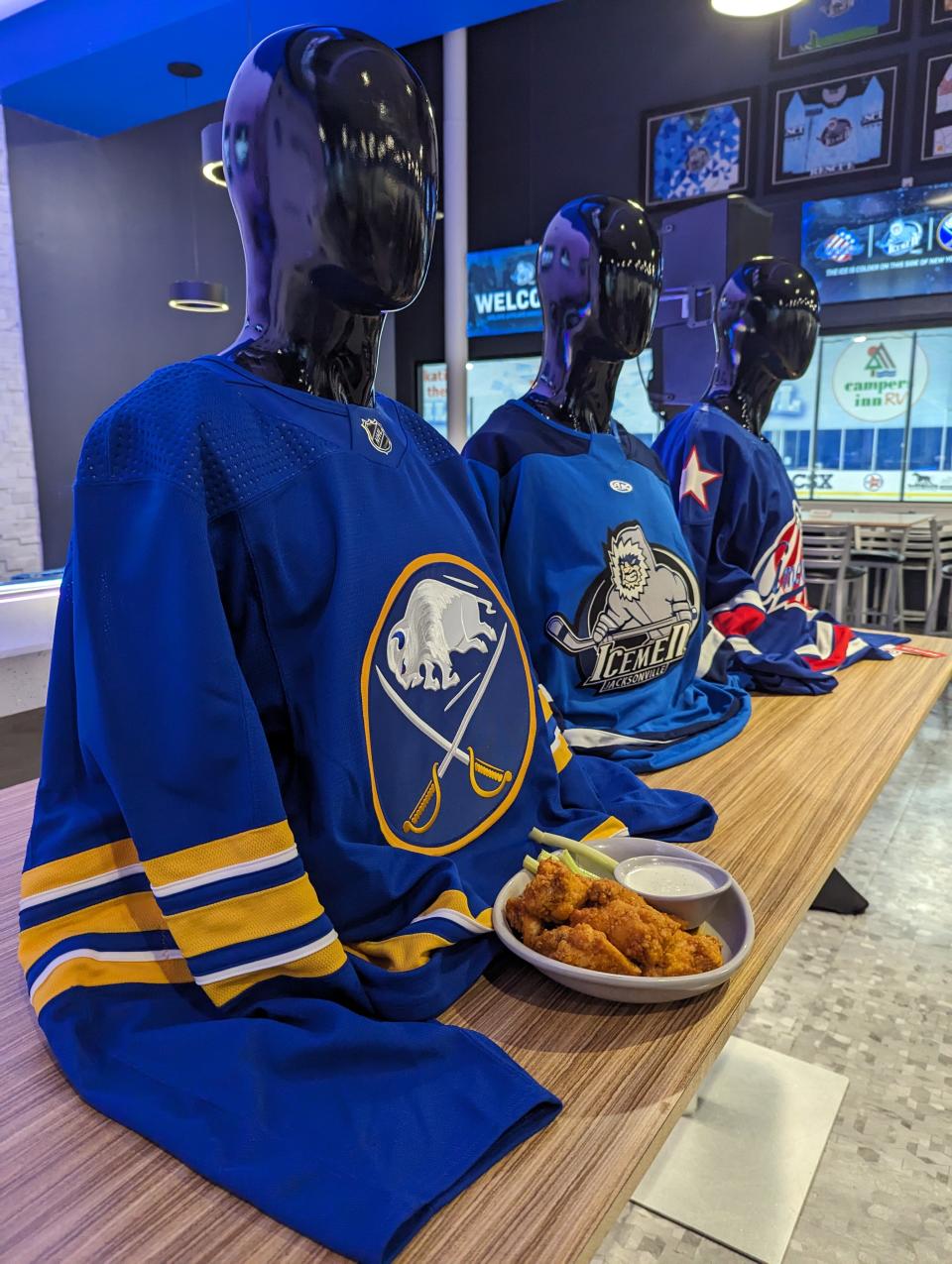 Buffalo Sabres, Jacksonville Icemen and Rochester Americans hockey sweaters are lined up at the Icemen's affiliation announcement at the Community First Igloo.