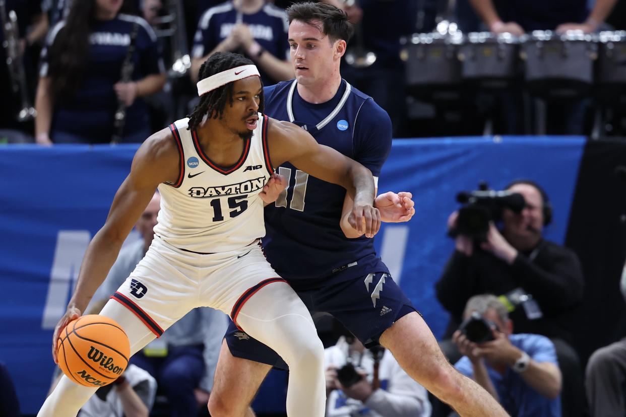 Dayton forward Daron Holmes II (15) dribbles against Nevada forward Nick Davidson (11) during the first half in the first round of the NCAA Tournament on March 21 in Salt Lake City.