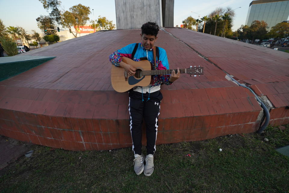A man play his guitar during a national protest against the murder of journalist Lourdes Maldonado and freelance photojournalist Margarito Martínez, at the Mexico monument in Tijuana, Mexico, Tuesday, Jan. 25, 2022. Mexico's Interior Undersecretary Alejandro Encinas said recently that more than 90% of murders of journalists and rights defenders remain unresolved, despite a government system meant to protect them. (AP Photo/Marco Ugarte)
