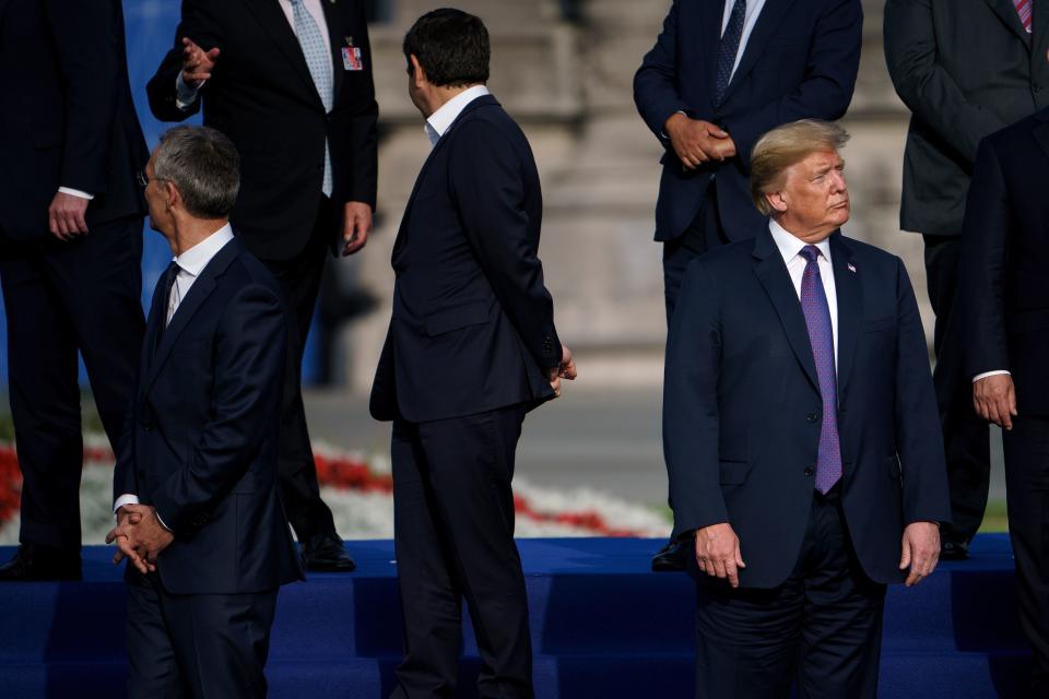 <p>President Trump, right, waits with NATO Secretary-General Jens Stoltenberg before they pose ahead of a working dinner at the Parc du Cinquantenaire in Brussels on July 11, 2018, during the NATO summit. (Photo: Brendan Smialowski/AFP/Getty Images) </p>