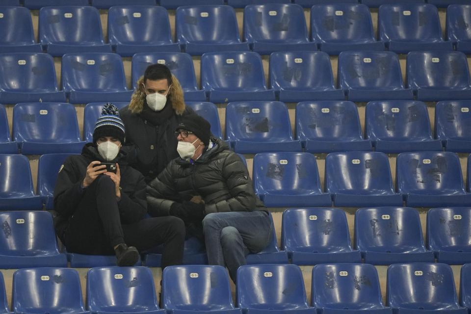 Inter soccer fans wearing FFP2 face masks wait for the start of the Serie A soccer match between Inter Milan and Lazio at the San Siro Stadium, in Milan, Italy, Sunday, Jan. 9, 2022. With Italy's hospital ICUs rapidly filling up with COVID-19 patients, most of them unvaccinated, Premier Mario Draghi’s government issued a Christmas Eve decree that FFP2 masks – which are more protective for users than cloth or surgical face masks – must be worn used on public transport, including planes, trains, ferries and local buses, trams and subways. (AP Photo/Antonio Calanni)