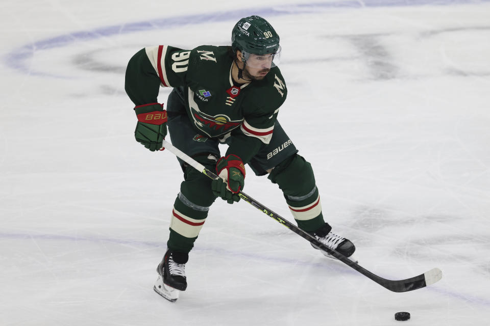 Minnesota Wild left wing Marcus Johansson (90) handles the puck during the first period of an NHL hockey game against the Boston Bruins, Sunday, March 18, 2023, in St. Paul, Minn. (AP Photo/Stacy Bengs)