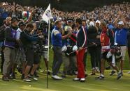 Team Europe golfer Jamie Donaldson (centre L) shakes hands with U.S. player Keegan Bradley after winning their match to retain the Ryder Cup for Europe on the 15th green during the 40th Ryder Cup at Gleneagles in Scotland September 28, 2014. REUTERS/Phil Noble (BRITAIN - Tags: SPORT GOLF)