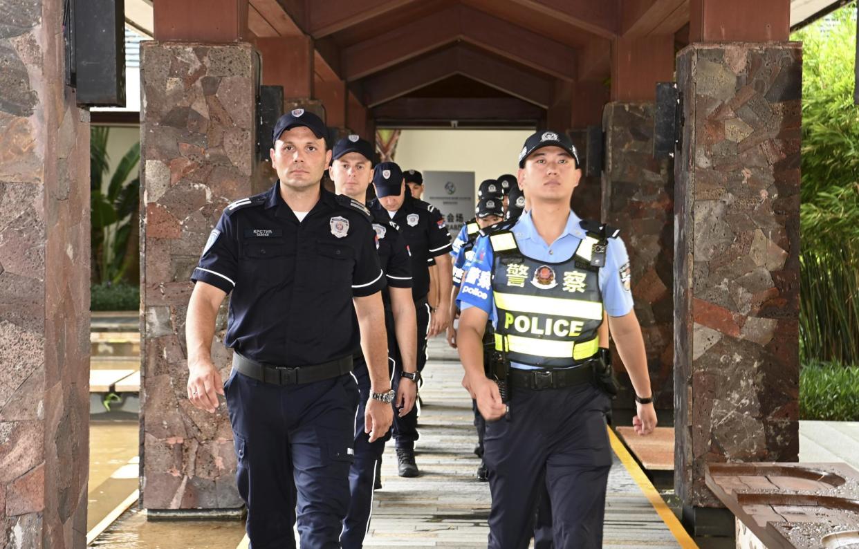 <span>Serbian and Chinese police officers carry out a joint patrol in Sanya, south China's Hainan province, on 7 September. China plans to train thousands of foreign law enforcement officers.</span><span>Photograph: Xinhua/REX/Shutterstock</span>