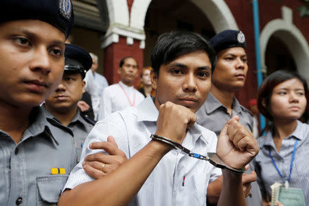 Detained Reuters journalist Kyaw Soe Oo is escorted by police while leaving Insein court in Yangon, Myanmar July 2, 2018. REUTERS/Ann Wang/Files