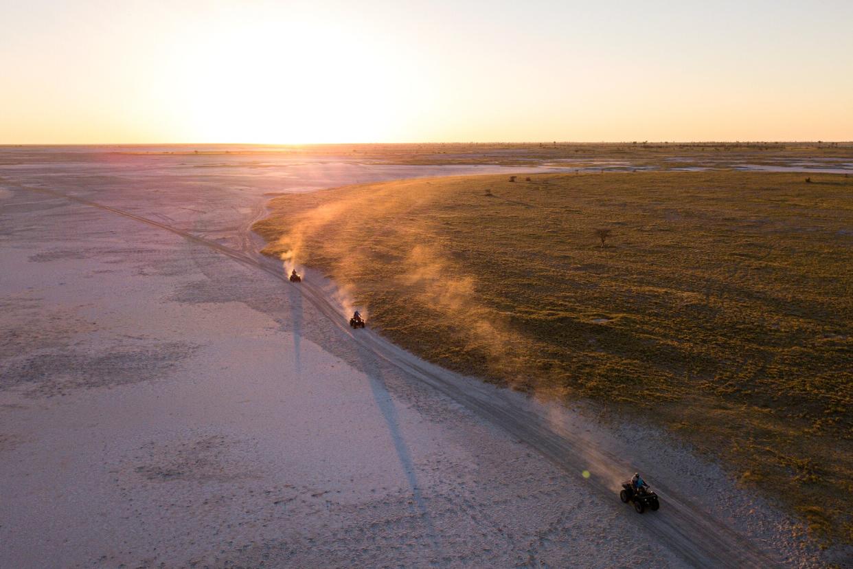 Quad biking across salt flats in Botswana