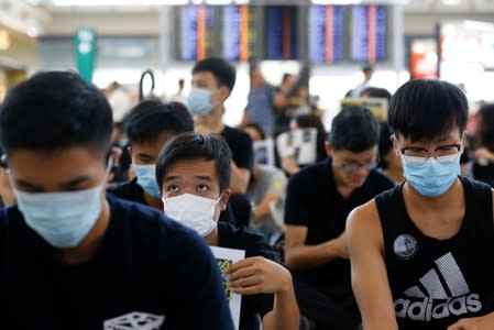 Anti-extradition bill demonstrators attend a protest at the arrival hall of Hong Kong International Airport