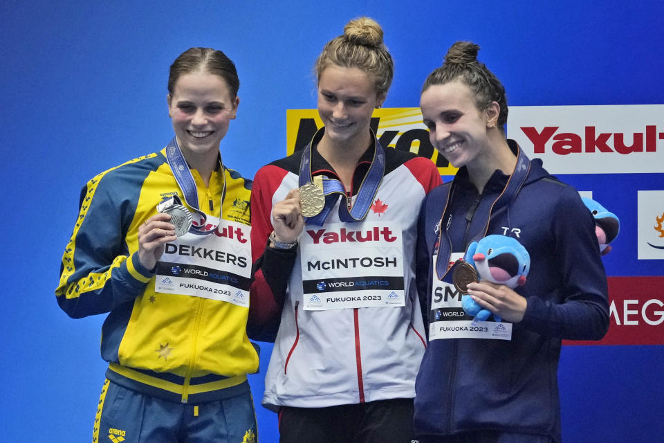 Medalists, from left to right, Australia's Elizabeth Dekkers, silver, Canada's Summer McIntosh, gold, and Regan Smith of the U.S., bronze, celebrate on the podium during the medal ceremony for the women's 200m butterfly at the World Swimming Championships in Fukuoka, Japan, Thursday, July 27, 2023. (AP Photo/Lee Jin-man)