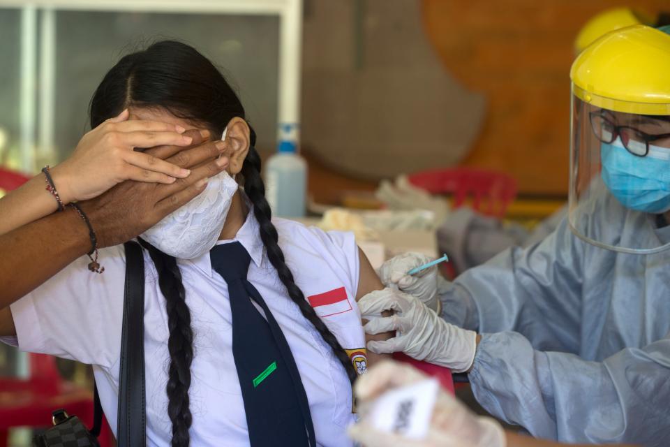 A teenager receives a shot of the Sinovac vaccine in Bali, Indonesia, on 5 July (Copyright 2021 The Associated Press. All rights reserved.)