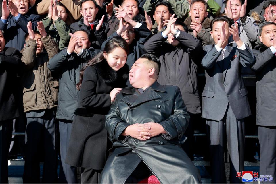 North Korean leader Kim Jong Un, center right, and his daughter, center left, with soldiers, pose for a photo, following the launch of what it says a Hwasong-17 intercontinental ballistic missile (Associated Press/ KCNA)