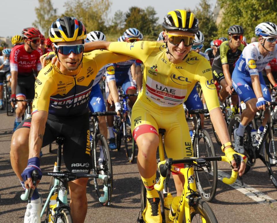 Primoz Roglic, left, who lost his overall leader’s yellow jersey to Tadej Pogacar, right, hug during the twenty-first and last stage from Mantes-La-Jolie to Paris.