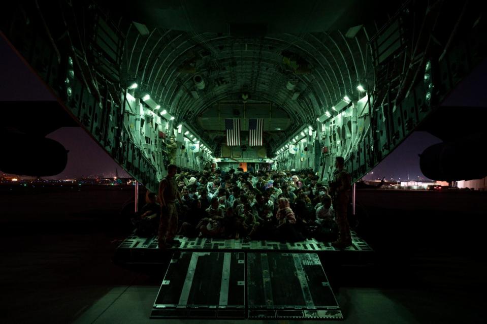 A US Air Force crew assists evacuees aboard an aircraft after the Taliban took Kabul in 2021 (US Air Force)