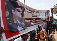 Supporters of the military hold a banner of Army chief General Abdel Fattah al-Sisi outside the Egyptian High Court in Cairo November 4, 2013. Ousted Egyptian president Mohamed Mursi struck a defiant tone on the first day of his trial on Monday, chanting 'Down with military rule', and calling himself the country's only 'legitimate' president. Mursi, an Islamist who was toppled by the army in July after mass protests against him, appeared angry and interrupted the session repeatedly, prompting a judge to adjourn the case. The banner reads as "Sisi, president of Egypt". REUTERS/Mohamed Abd El Ghany (EGYPT - Tags: POLITICS MILITARY CIVIL UNREST CRIME LAW)