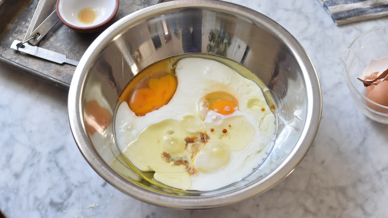 combining wet pancake ingredients eggs
