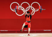 <p>TOKYO, JAPAN - JULY 25: Fabin Li of Team China competes during the Weightlifting - Men's 61kg Group A on day two of the Tokyo 2020 Olympic Games at Tokyo International Forum on July 25, 2021 in Tokyo, Japan. (Photo by Chris Graythen/Getty Images)</p> 