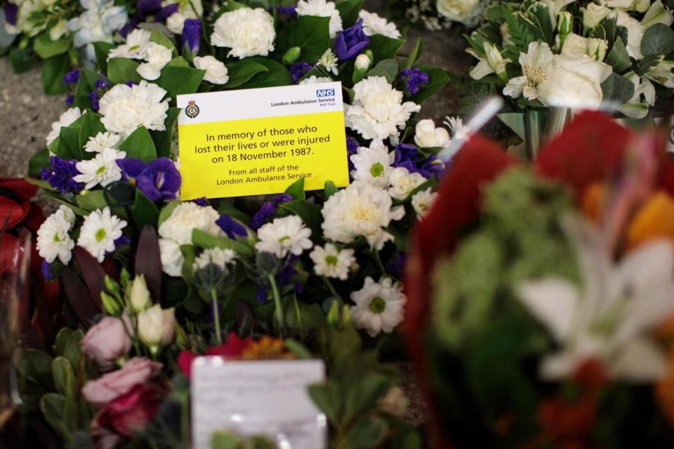 Flowers laid beneath a memorial plaque (Getty Images)