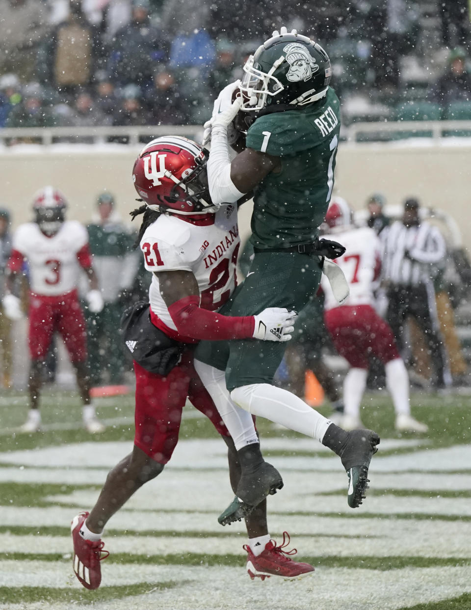 Indiana defensive back Noah Pierre (21) pushes Michigan State wide receiver Jayden Reed (1) out of bounds during the second overtime of an NCAA college football game, Saturday, Nov. 19, 2022, in East Lansing, Mich. (AP Photo/Carlos Osorio)