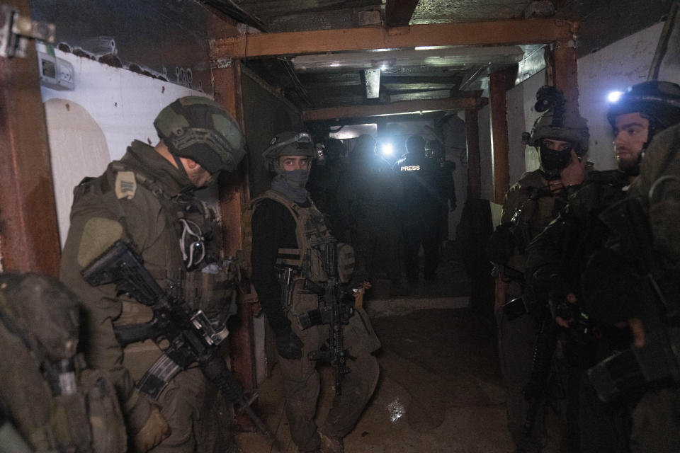 Israeli soldiers stand in a Hamas tunnel underneath a cemetery during the ground offensive on the Gaza Strip in Khan Younis, Saturday, Jan. 27, 2024. (AP Photo/Sam McNeil)