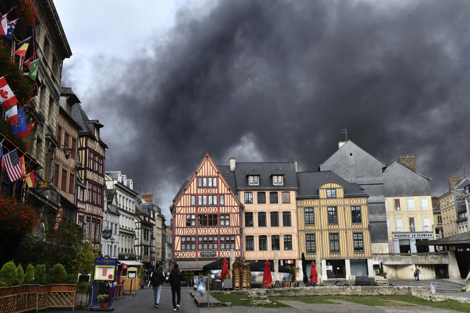 Black smoke is pictured from the historical center of Rouen, Normandy, after a fire broke at a chemical plant Thursday, Sept.26, 2019. An immense mass of black smoke is rising over Normandy as firefighters battle a blaze at a chemical plant, and authorities closed schools in 11 surrounding towns and asked residents to stay indoors. (AP Photo/Stephanie Peron)