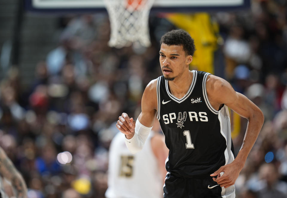 San Antonio Spurs center Victor Wembanyama drops back to defend after hitting a basket against the Denver Nuggets during the first half of an NBA basketball game Tuesday, April 2, 2024, in Denver. (AP Photo/David Zalubowski)