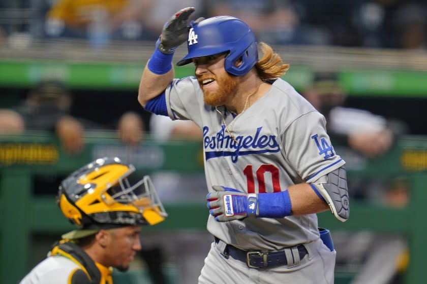 Los Angeles Dodgers' Justin Turner (10) celebrates after crossing home plate after hitting a solo home run.