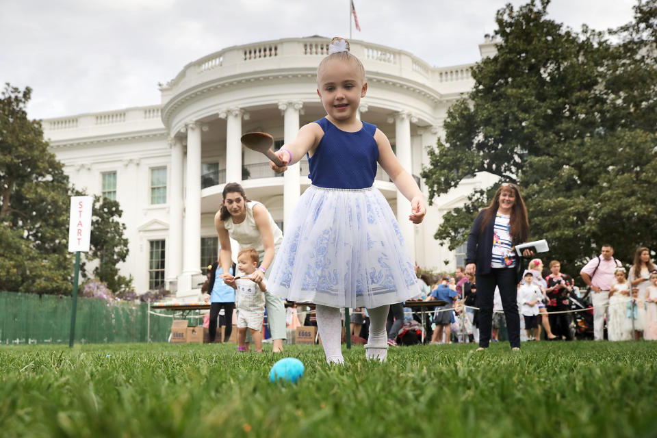 Four-year-old Vittoria Colonna of Marcus Hook, Pennsylvania, rolls a colored egg down the White House South Lawn.