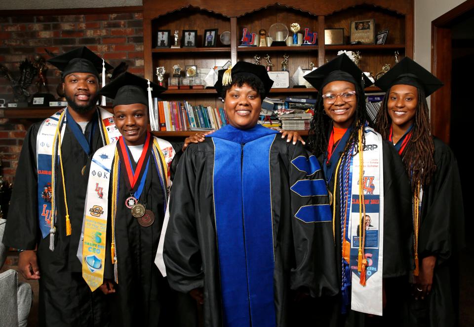 From left to right, Elijah Muhammad Jr., 19; Elijah Muhammad, 13; Atashia Muhammad, Ph.D.; Shania Muhammad, 15; and Rashay Muhammad, 21, pose for a photo Wednesday at their home in Oklahoma City. The family members all hold college degrees.