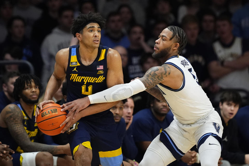 Villanova's Justin Moore, right, fouls Marquette's Stevie Mitchell during the second half of an NCAA college basketball game, Tuesday, Jan. 30, 2024, in Villanova, Pa. (AP Photo/Matt Slocum)