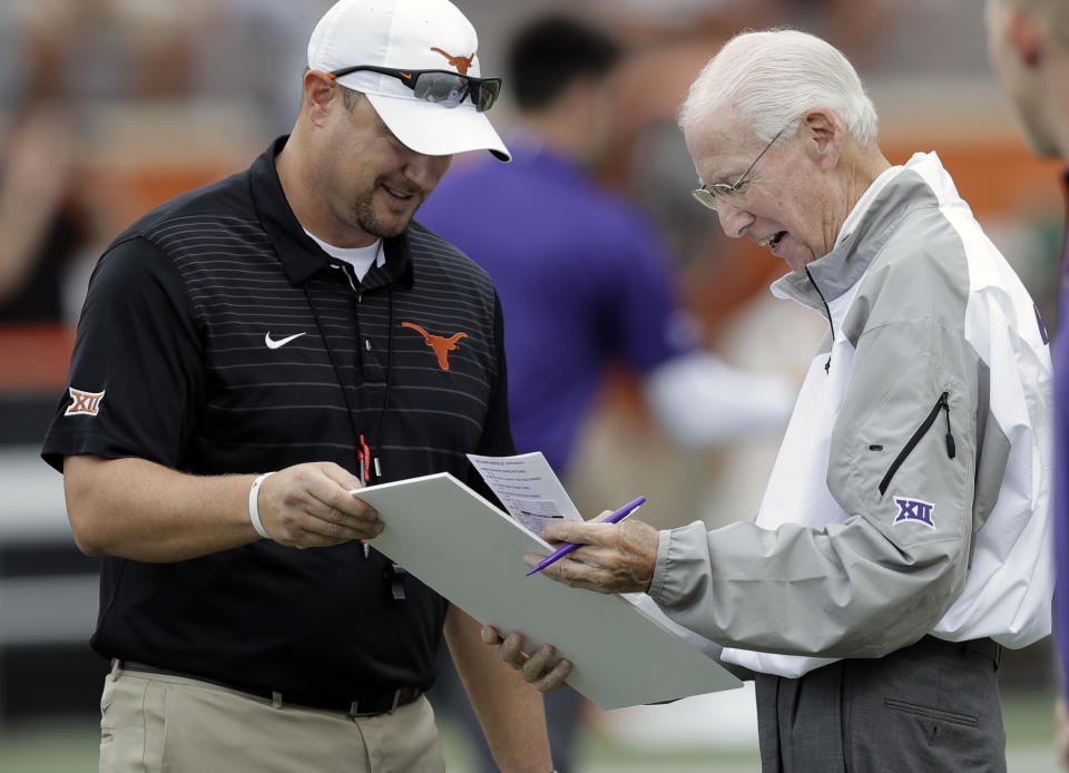 Texas head coach Tom Herman, left, presents a birthday card signed by Texas players and coaches to Kansas State head coach Bill Snyder, who is celebrating his birthday today, before their NCAA college football game, Saturday, Oct. 7, 2017, in Austin, Texas. Snyder is 78 today. (AP Photo/Eric Gay)