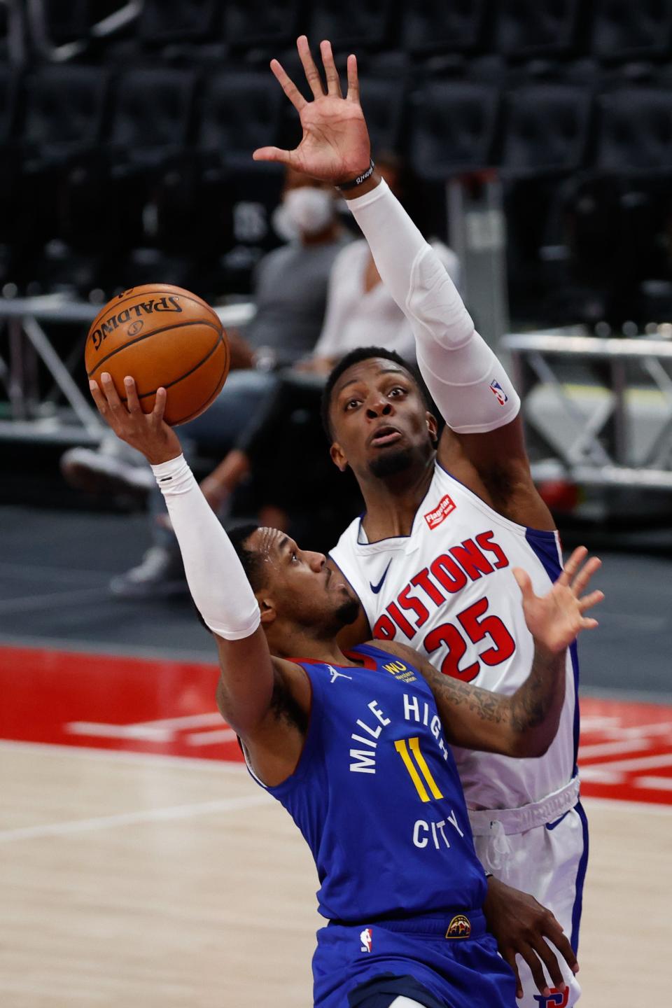 Denver Nuggets guard Monte Morris shoots on Detroit Pistons forward Tyler Cook in the second half at Little Caesars Arena, May 14, 2021.