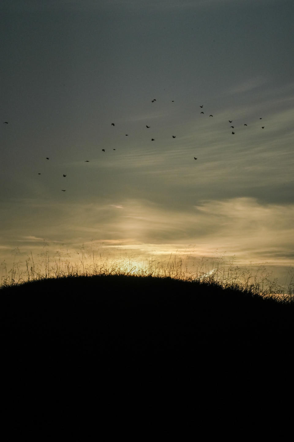 The sun rises over one of the Twin Mounds at Fort Ancient Earthworks, Tuesday, Sept. 19, 2023, in Oregonia, Ohio. Fort Ancient is part of a network of ancient American Indian ceremonial and burial mounds around Ohio that were added to the list of UNESCO World Heritage sites. (AP Photo/Joshua A. Bickel)