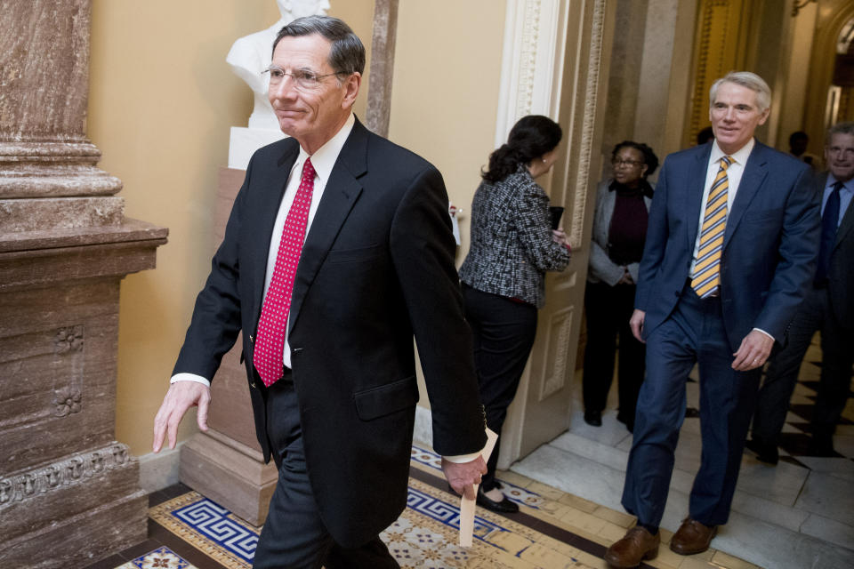 Rep. John Barrasso, R-Wyo., left, and Sen. Rob Portman, R-Ohio, right, walk to a meeting with Republican Senate leadership at the offices of Senate Majority Leader Mitch McConnell of Ky. on Capitol Hill, Monday, Feb. 11, 2019, in Washington. (AP Photo/Andrew Harnik)