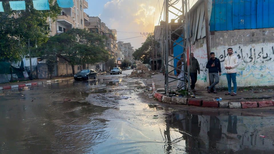 Gaza residents wander around their ruined streets full of rubble, stagnant water and trash. - Scott McWhinnie/CNN