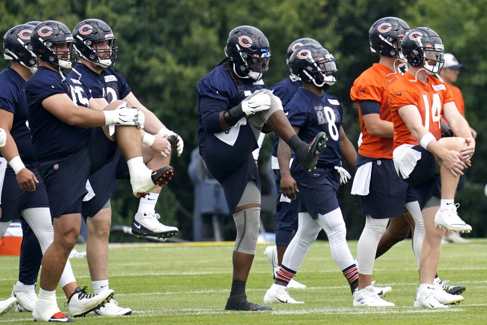 Chicago Bears players warm up during NFL football practice in Lake Forest, Ill., Wednesday, July 28, 2021. (AP Photo/Nam Y. Huh)