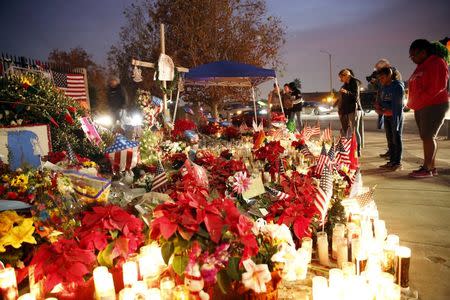 Flowers and candles are displayed at a makeshift memorial after last week's shooting in San Bernardino, California December 10, 2015. REUTERS/Patrick T. Fallon