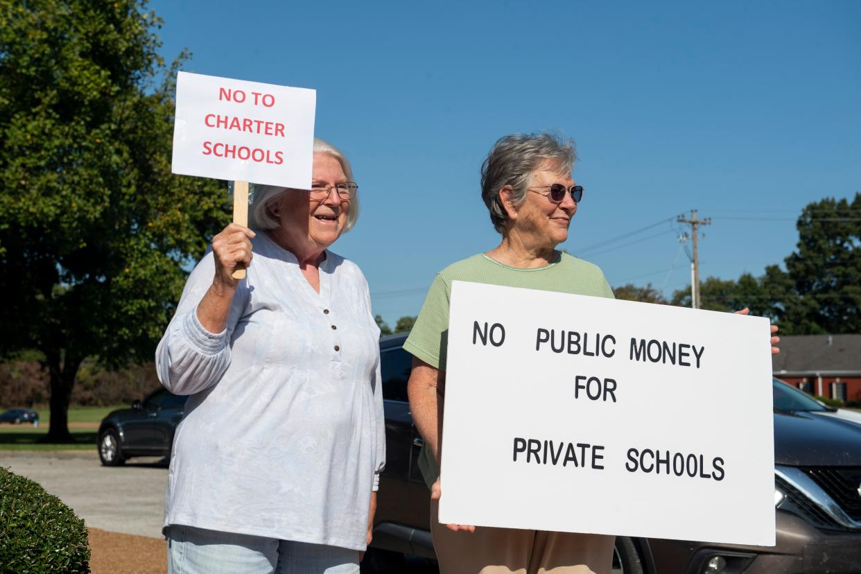 Sue Barnes and Ann Van der Linde hold up signs opposing American Classical Academy outside of the Jackson-Madison County Board of Education building before the start of the American Classical Academy Madison County Charter School Appeal Public Hearing on Thursday, September 15, 2022, in Jackson, Tenn. “I think that the public school system is the best thing that the United States has going for it to carry on a democracy, separation of church and state, patriotism, everything to be a fine nation,” Van der Linde said. “And I don’t like having public schools denigrated by anybody who thinks that “we can do it better than you.””