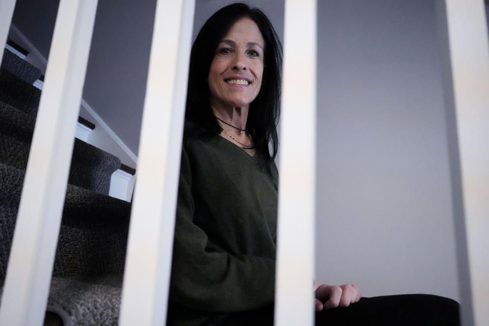 Jill Feldman, 54, poses for a photo at her home in Deerfield, Ill., Friday, Jan. 19, 2024. Lung cancer patient and advocate Jill Feldman takes pills at home that shrink tumors by blocking a signal that tells cancer cells to grow. (AP Photo/Nam Y. Huh)