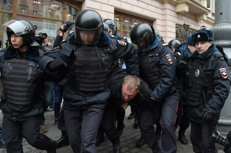 Russian police officers detain a man in central Moscow on April 2, 2017, as Russian opposition promised protests after police detained hundreds of people during anti-corruption rallies