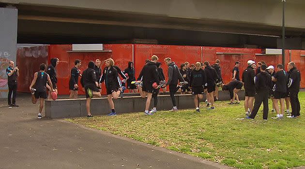 Port Adelaide players stretch while on a walk through Melbourne this morning ahead of tonight's semi final against Geelong. Photo: 7News.