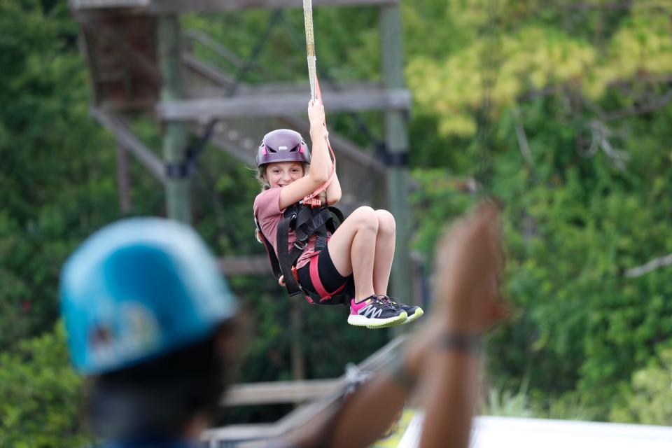 Gatorland visitors zip-line at the family-run amusement park on June 25, 2024 in Orlando, Florida.