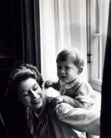 <p>Â© Cecil Beaton / Victoria and Albert Museum, London</p> Princess Elizabeth in playful pose with Prince Charles at Clarence House in 1950