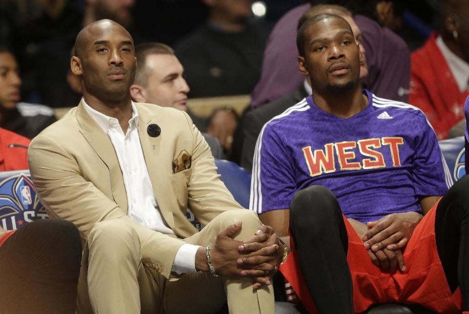 Los Angeles Lakers Kobe Bryant, left, sits with West Team's Kevin Durant, of the Oklahoma City Thunder during the NBA All Star basketball game, Sunday, Feb. 16, 2014, in New Orleans. (AP Photo/Gerald Herbert)