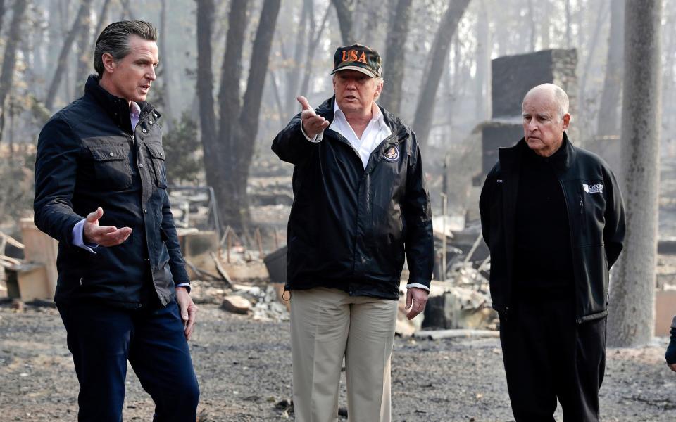 President Donald Trump talks with then Gov.-elect Gavin Newsom, left, as California Gov. Jerry Brown listens during a visit to a neighborhood impacted by the wildfires in Paradise, Calif. State Republicans have approved a rule change intended to ensure the party can send delegates to the GOP's national convention next summer, even if President Trump is kept off the state's 2020 primary ballot. The measure is a response to a law signed by Democratic Gov. Newsom in July that requires presidential candidates to release their tax returns, a move clearly aimed at the Republican president.