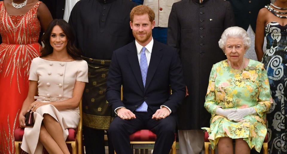 Meghan Markle sits with Prince Harry and the Queen at an event in 2018. (Getty Images)